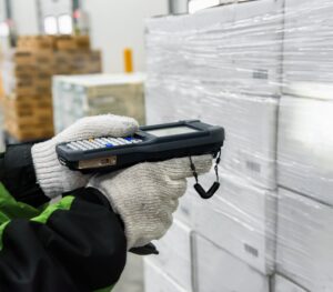 Bluetooth barcode scanner checking goods in the cold room or warehouse. Selection focus shooting on Bluetooth barcode scanner.